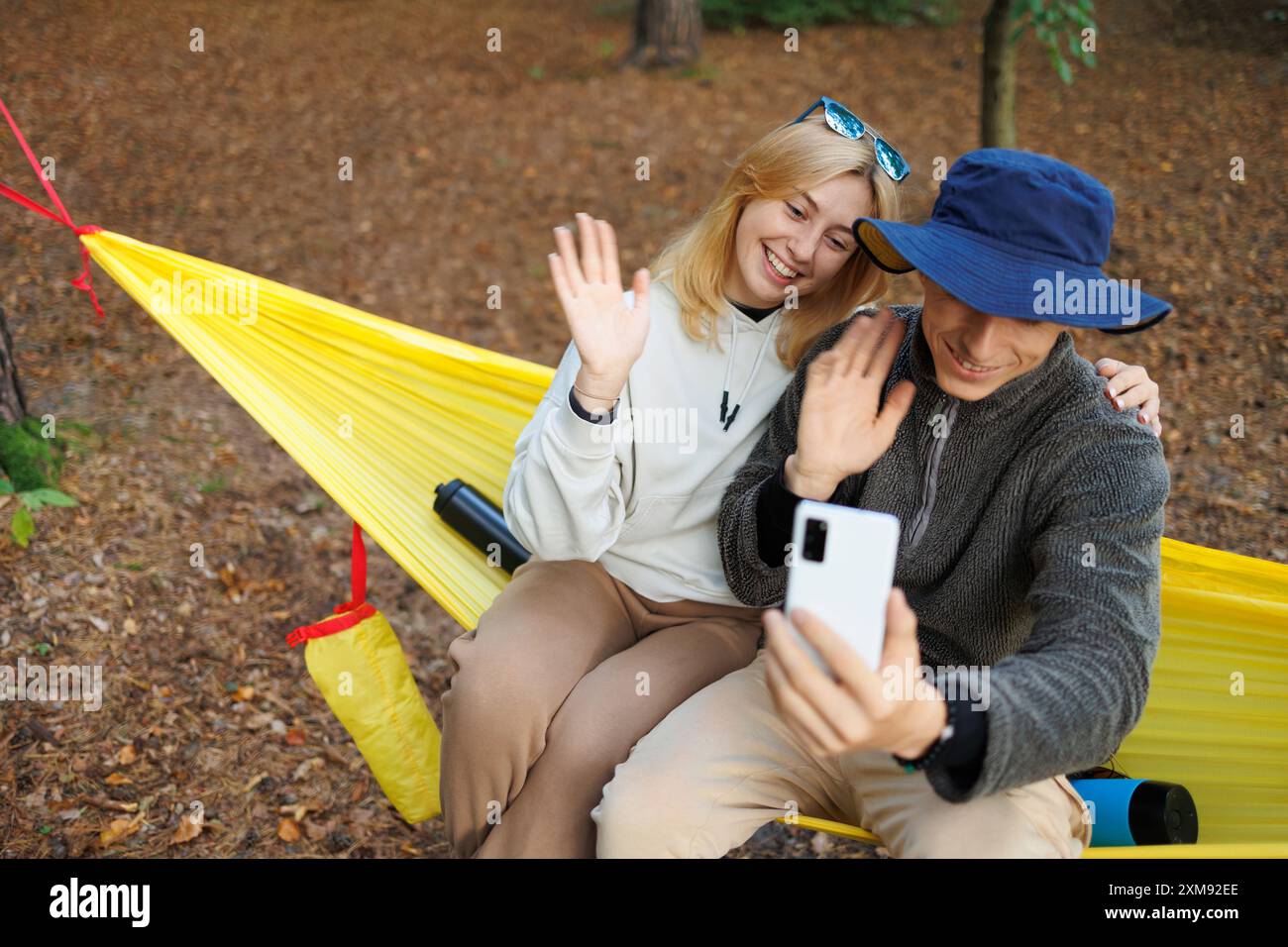 Young couple sharing hammock on