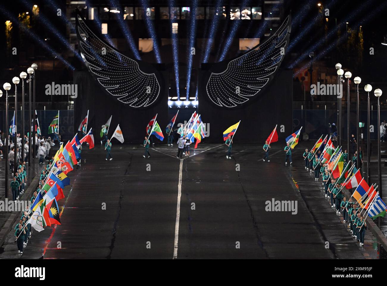 Volunteers carrying the flags of competing nations at the Trocadéro ...