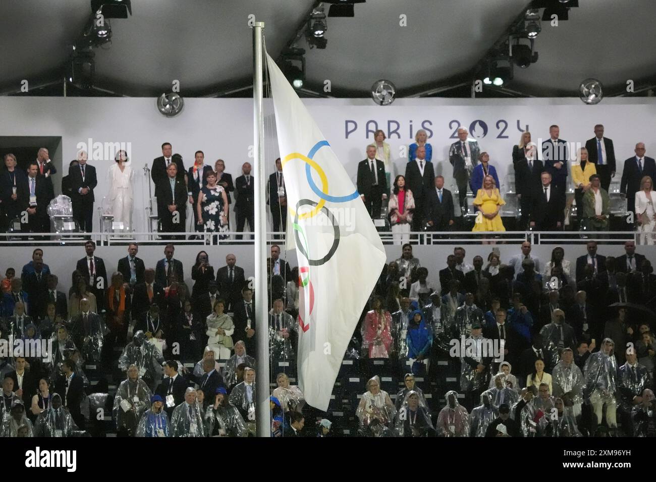 Paris, France. 26th July, 2024. The Olympic flag is raised during the ...