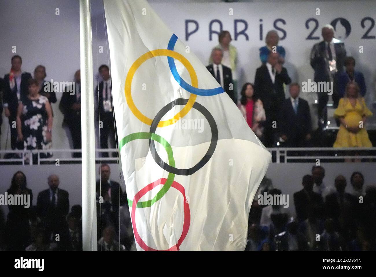 Paris, France. 26th July, 2024. The Olympic flag is raised during the ...