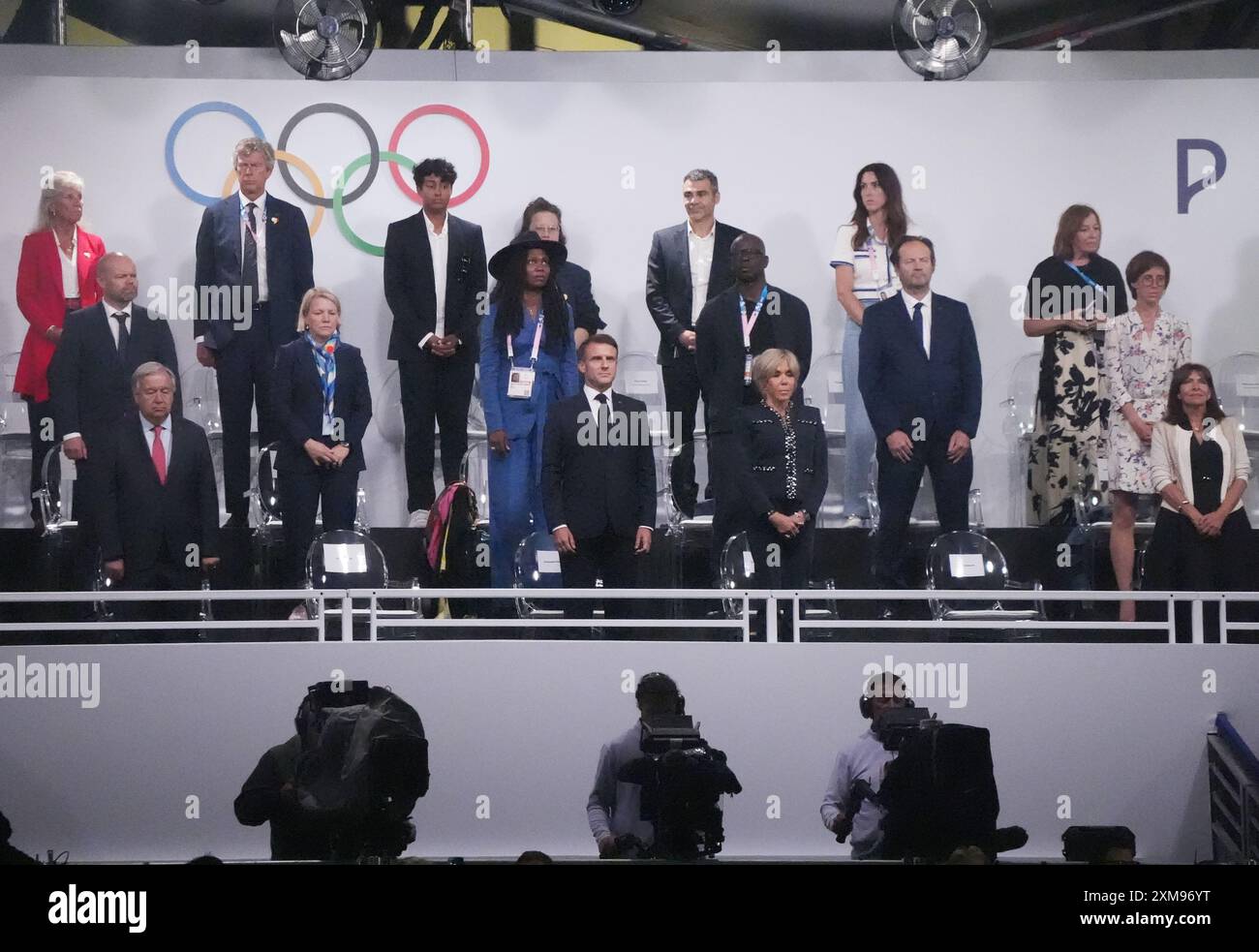 Paris, France. 26th July, 2024. Dignitaries stand as the Olympic flag ...