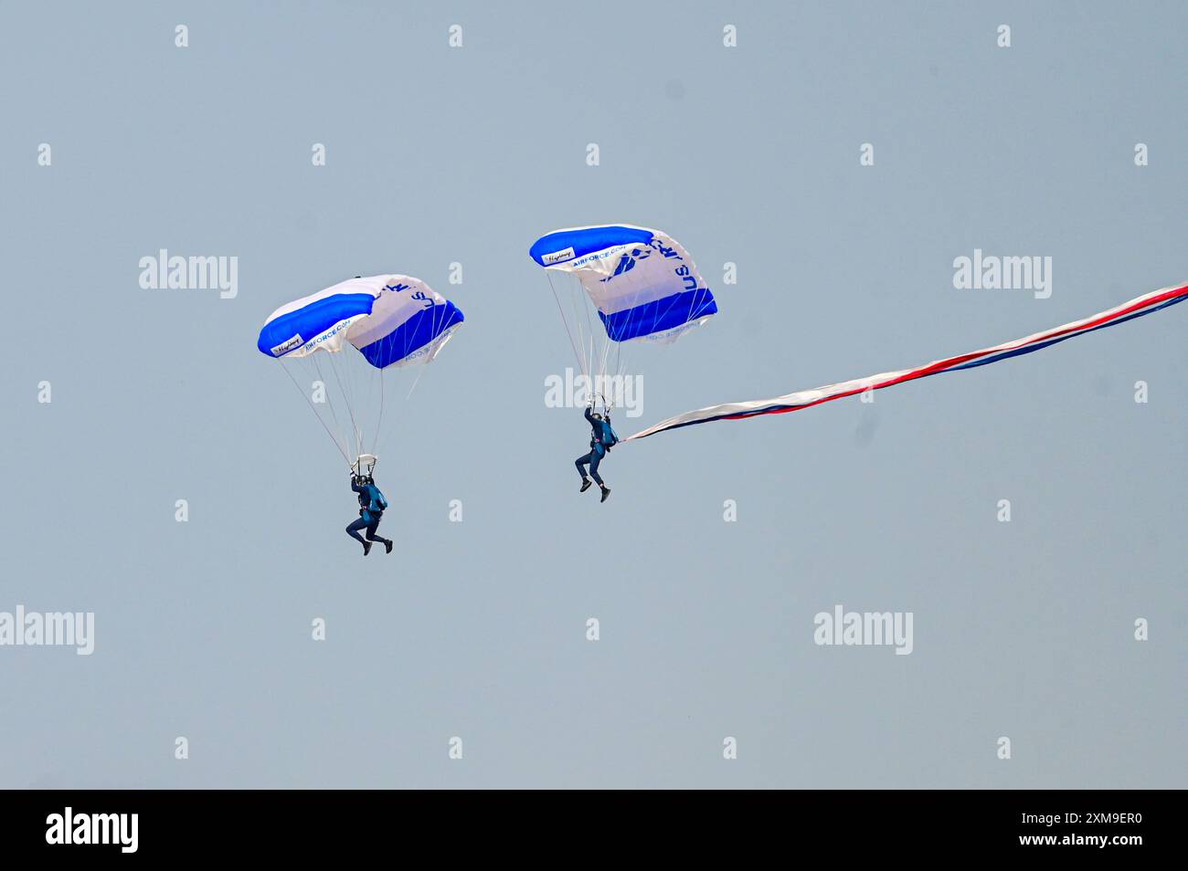 The U.S. Air Force Academy Wings of Blue parachute team come in for landing during the Wings Over Wyoming Airshow at F.E. Warren Air Force Base, Wyoming, July 24, 2024. The team opened for the U.S. Air Force Thunderbirds who travel across the United States performing their lineup of daunting routines for spectators to admire. (U.S. Air Force photo by Airman 1st Class Mattison Cole) Stock Photo