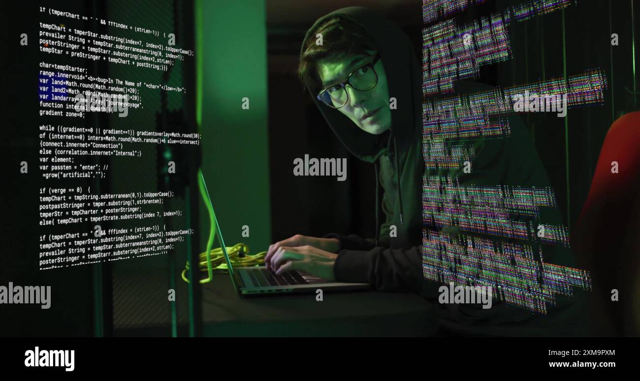 Typing on laptop, person in hoodie surrounded by digital code image. Technology, cybersecurity, hacker, coding, programming, computer Stock Photo