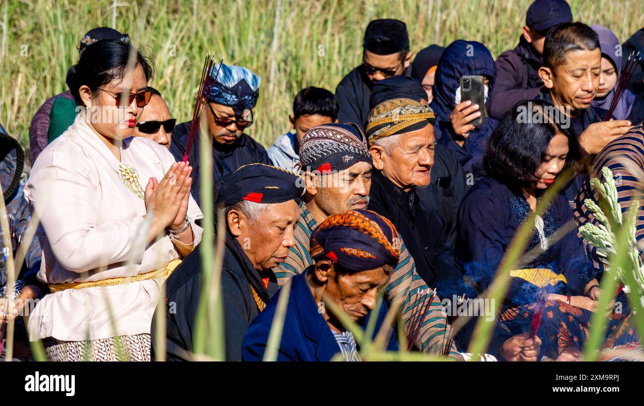 Javanese people pray during the Larungan ceremony on Mount Kelud Stock Photo