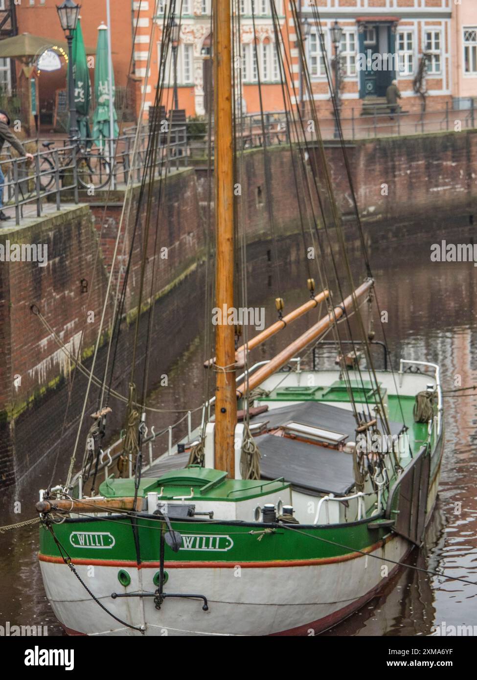 Close-up of a wooden boat on a canal in front of historic brick buildings, stade, germany Stock Photo