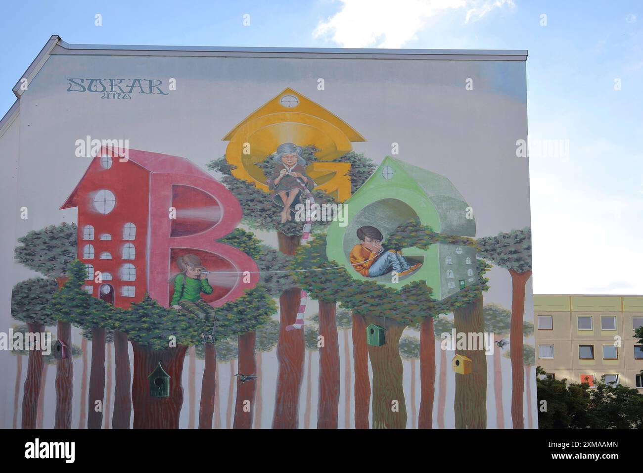 Mural by Sokar Uno, house wall with initials BGG and figures sitting in letters, abbreviation, birdhouses, street art, graffiti, housing, housing Stock Photo