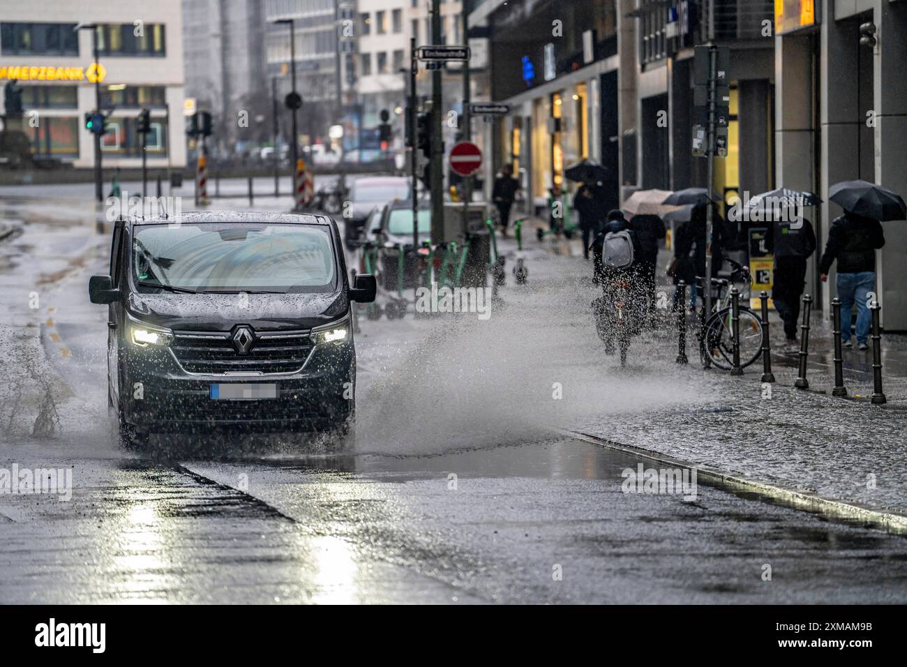 Winter, rainy weather, freezing rain, large puddle, puddle of water, in the city centre, Grosse Gallusstrasse, vehicles driving through, spraying Stock Photo