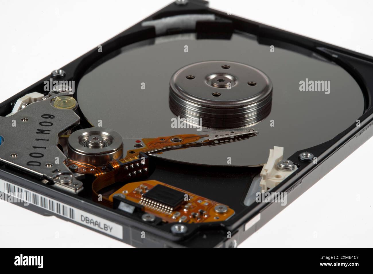 Computer hard drive, opened, read/write head on the storage disc. Symbol image Stock Photo