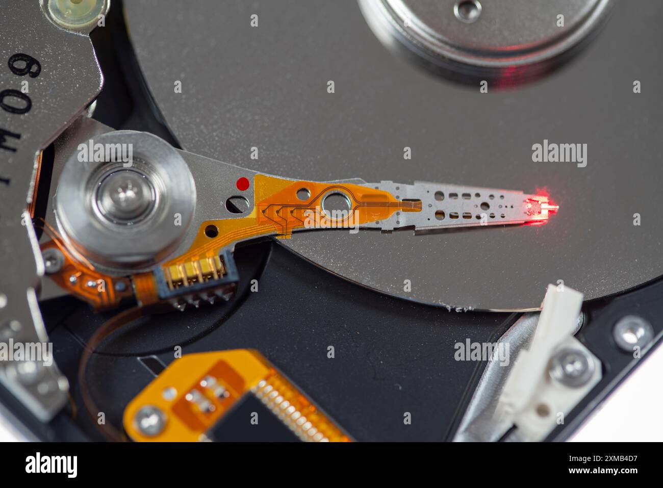 Computer hard drive, opened, read/write head on the storage disc. Symbol image Stock Photo