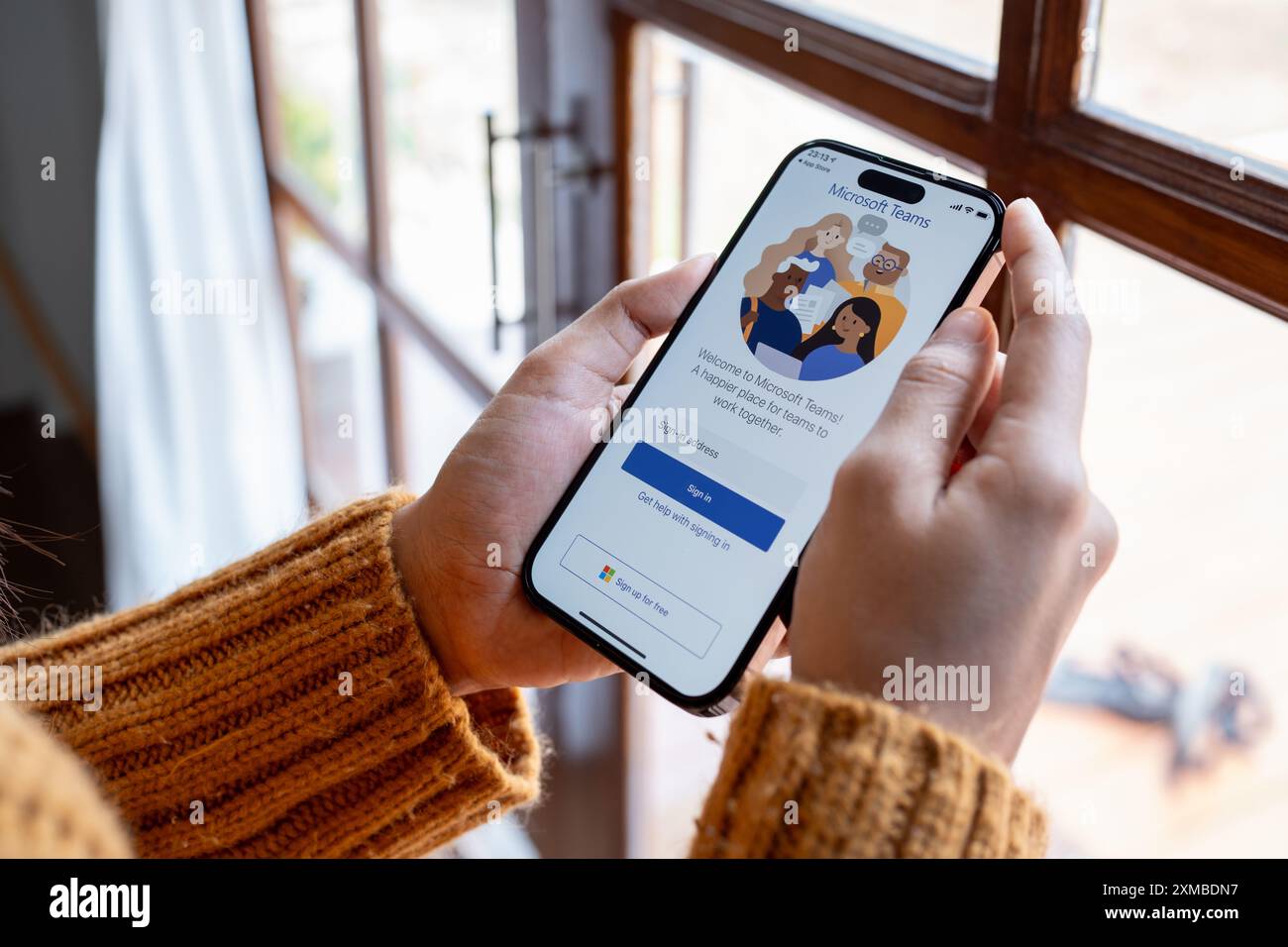 30 April 2023 Chiangmai, Thailand : Woman holding smartphone mobile show Microsoft Teams social platform, group chat platform app. Stock Photo