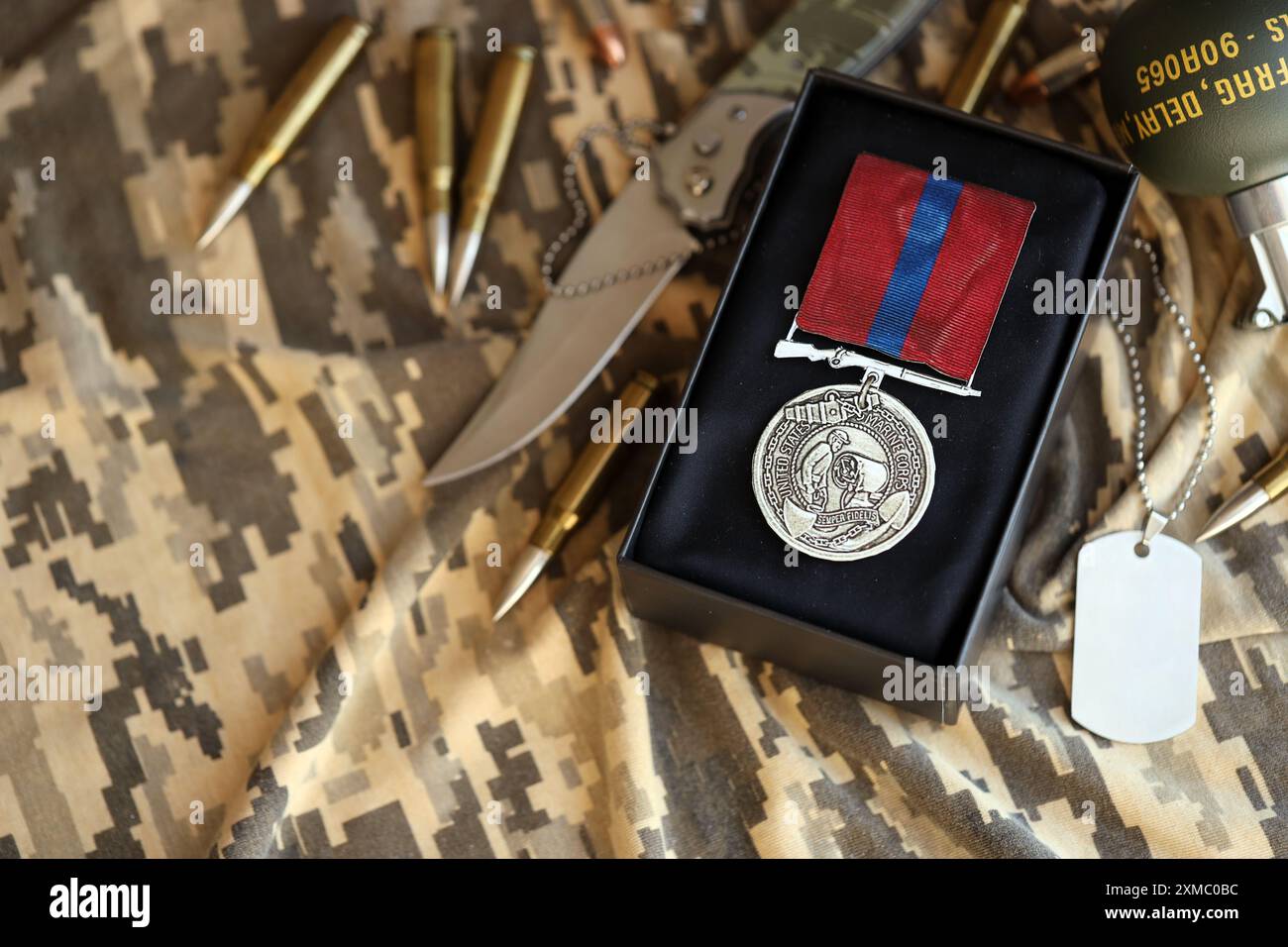 KYIV, UKRAINE - JULY 10, 2024 US Marine corps Army Good Conduct medal. United States military award medal with ribbon and pin. Handmade paper theater props close up Stock Photo