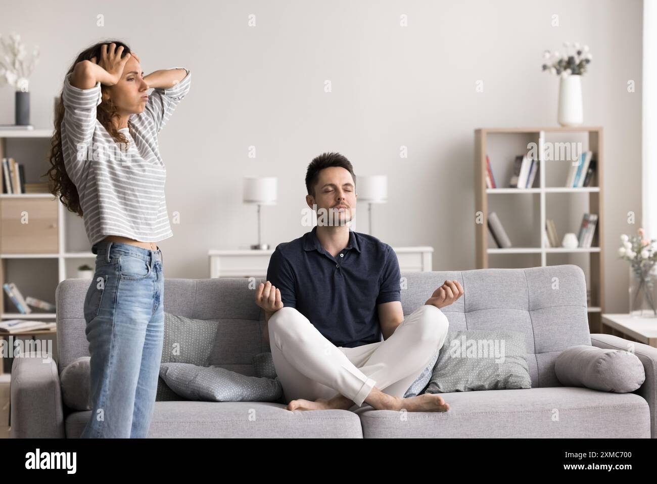 Husband Meditate While His Wife Throws A Tantrum Stock Photo Alamy