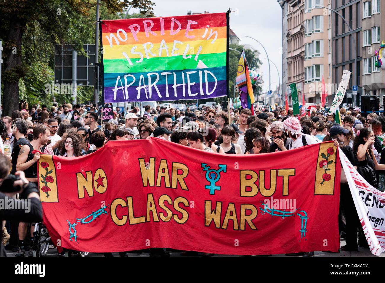 Berlin, Germany. 27th July, 2024. Participants in the Internationalist Queer Pride demonstration hold banners reading 'No Pride in Israel Apartheid' and 'NoWar But Class War' before the start of the 46th Berlin Pride parade for Christopher Street Day (CSD). The demonstration took place under the motto 'Queers for Palestine'. Credit: Carsten Koall/dpa/Alamy Live News Stock Photo