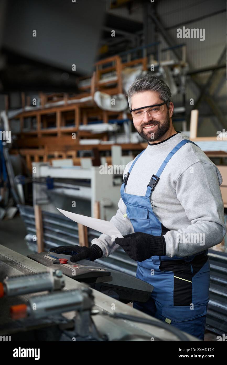 Professional with working documentation at the console of modern machine Stock Photo