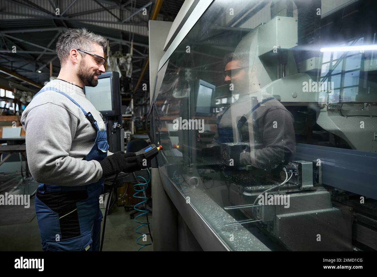 Professional uses a control panel to work on modern equipment Stock Photo
