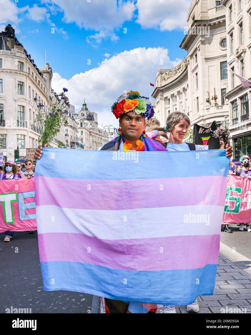 Trans Rallies London, UK. 27th July, 2024. Mohammed Nazir with a trans flag. The ...