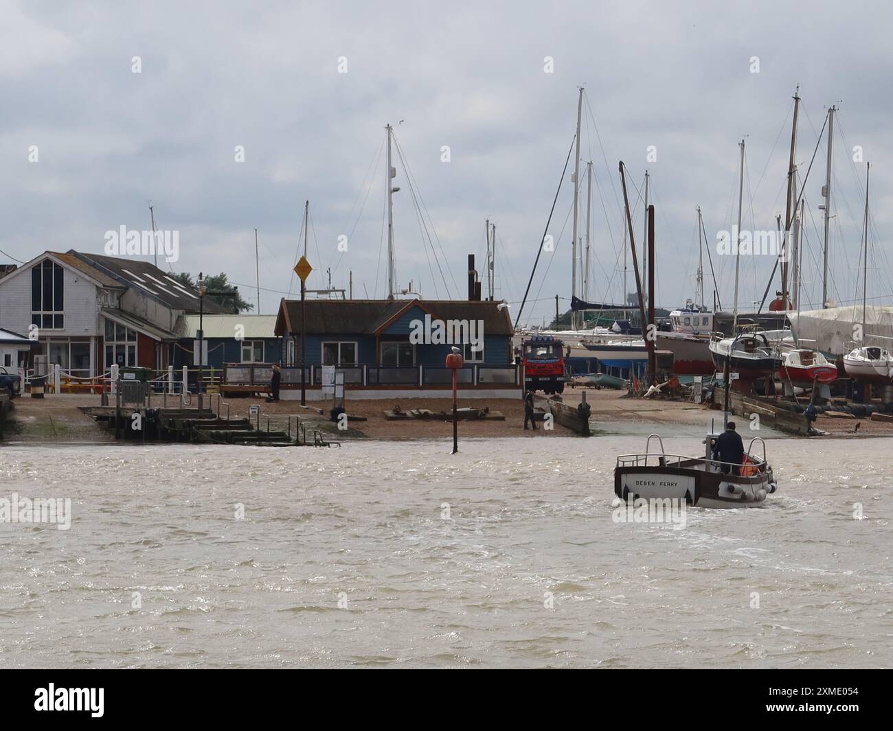 View of the hamlet of Felixstowe Ferry, with the Deben ferry boat offering foot passengers a crossing from the Bawdsey side of the estuary; Suffolk. Stock Photo