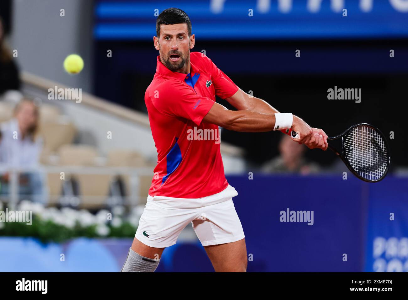 Paris, France, 27 July, 2024. Novak Djokovic of Serbia hits the ball during the Paris 2024 Olympic Games Mens First Round Tennis match between Novak Djokovic and Matthew Ebden at the Roland-Garros Stadium on July 27, 2024 in Paris, France. Credit: Pete Dovgan/Speed Media/Alamy Live News Stock Photo