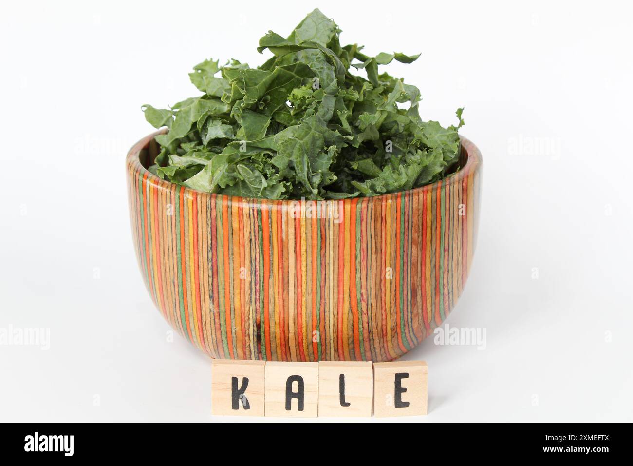Kale Lette Chopped kale in colorful bowl with letter tiles on white background ...