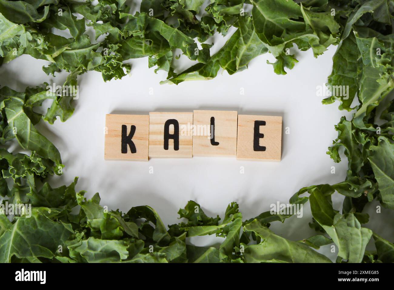 Kale Lette Kale leaves bordering letter tiles Stock Photo - Alamy