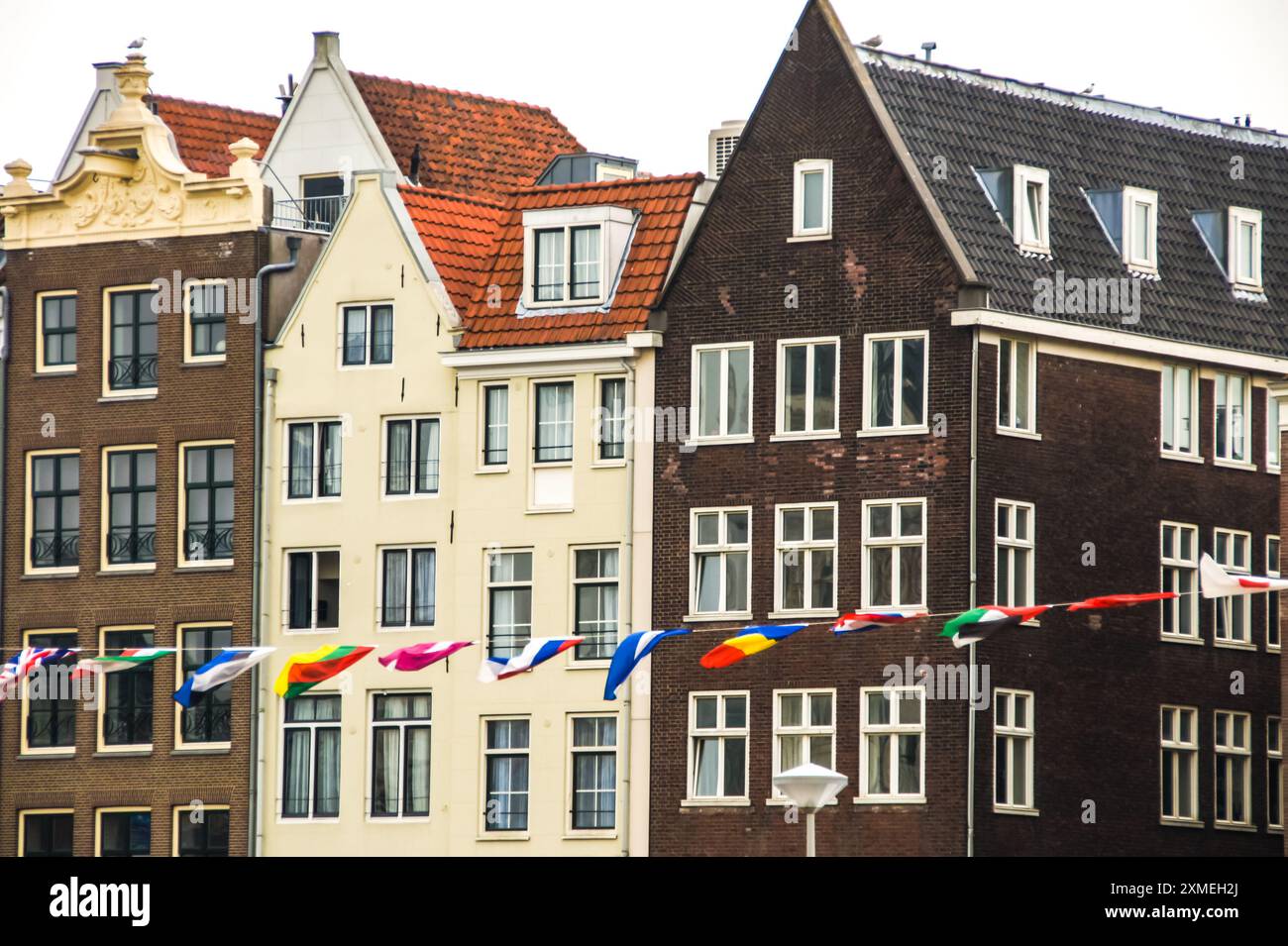 Amsterdam's iconic canal houses line the water, their colorful facades ...