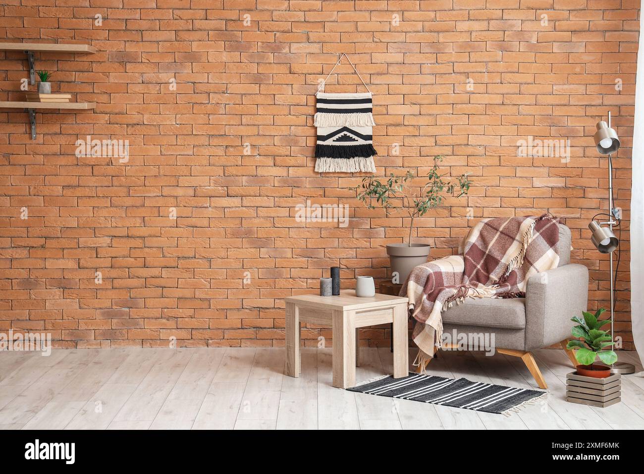 Interior of living room with grey armchair, table and lamp Stock Photo ...
