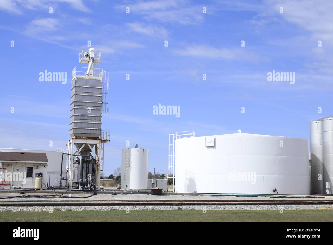 Fertilizer Tanks with railroad tracks and blue sky outdoor Stock Photo