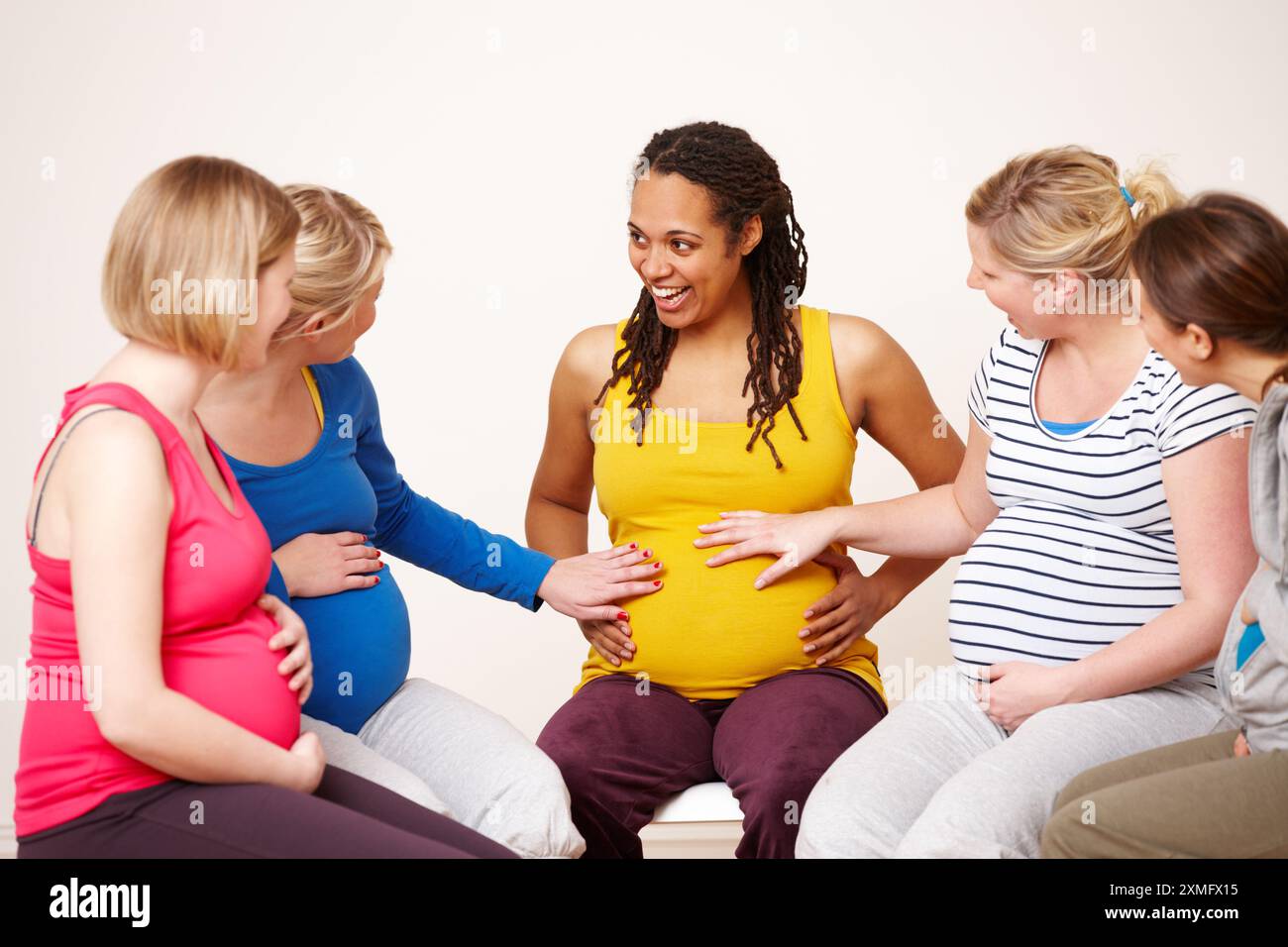 Pregnant woman laughing on exercise hi-res stock photography and images