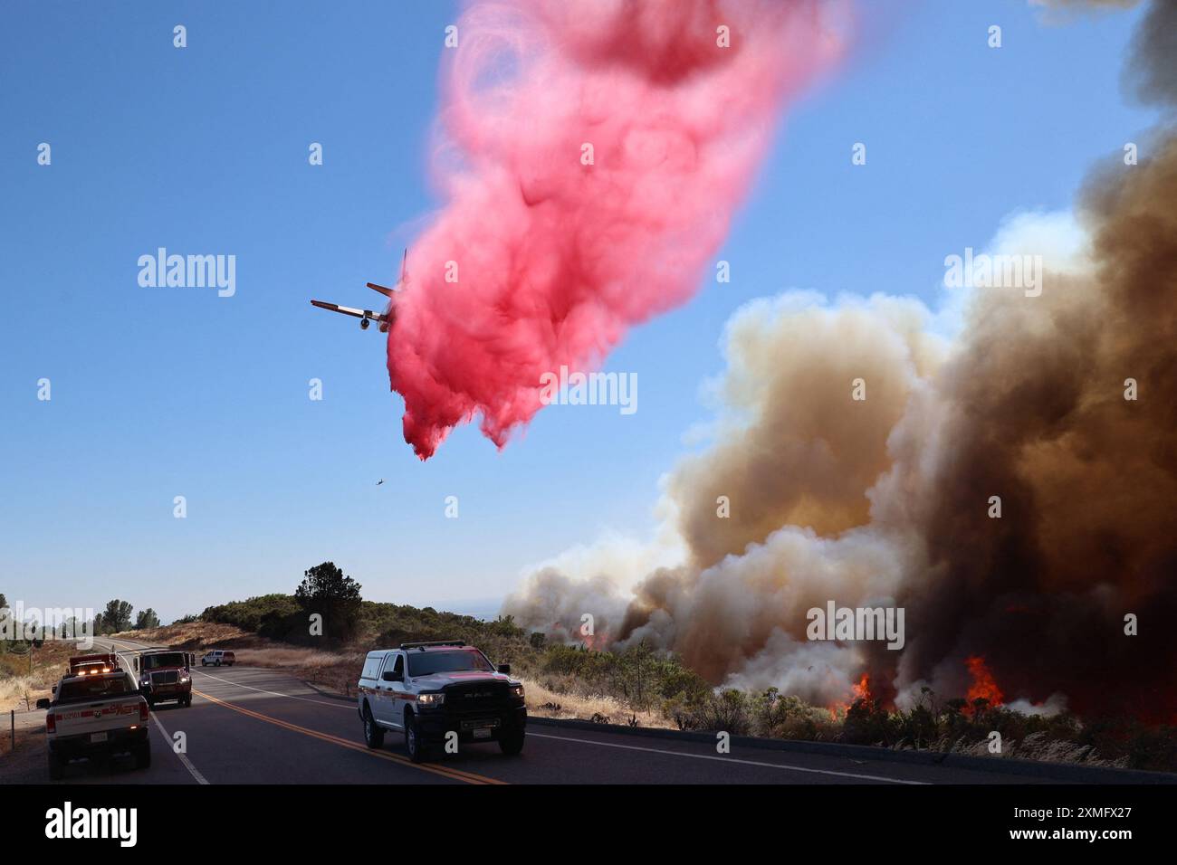 Handout photo shows firefighters battling against to flames on July 25 ...