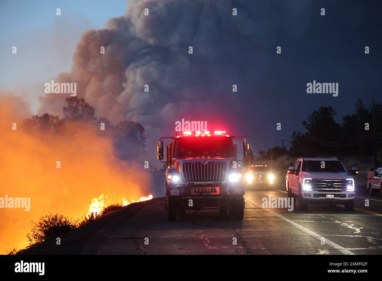 Handout photo shows firefighters battling against to flames on July 25 ...