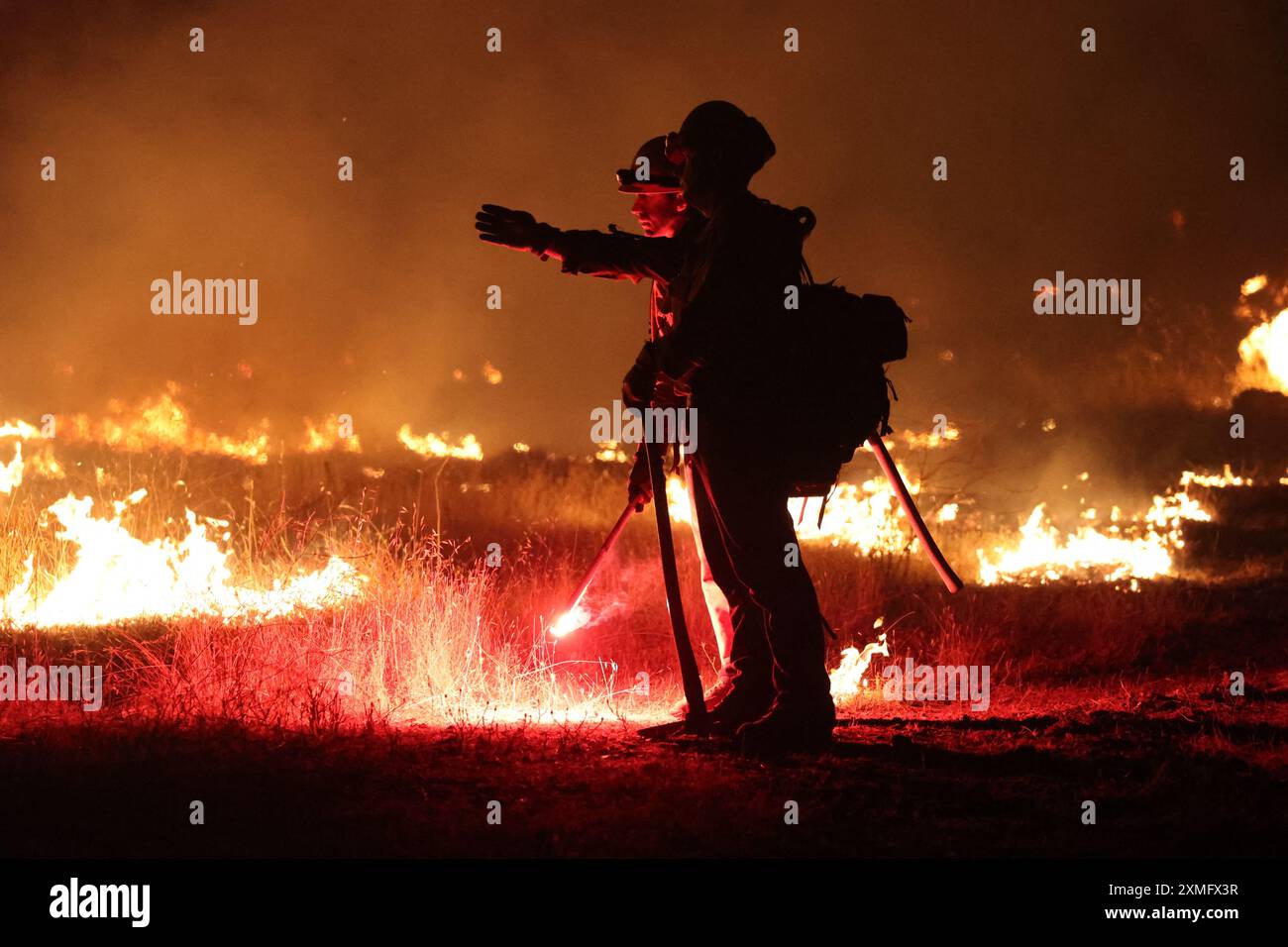 Handout photo shows firefighters battling against to flames on July 26 ...
