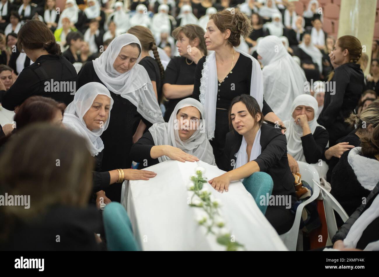 Majdal Shams, Israel. 28th July, 2024. Women mourn during the funeral of their relatives at the Druze town of Majdal Shams. Twelve children and young people were killed when a rocket fired by the Iran-backed Hezbollah militia in southern Lebanon hit a football field in the Israeli-occupied Golan Heights. Credit: Ilia Yefimovich/dpa/Alamy Live News Stock Photo