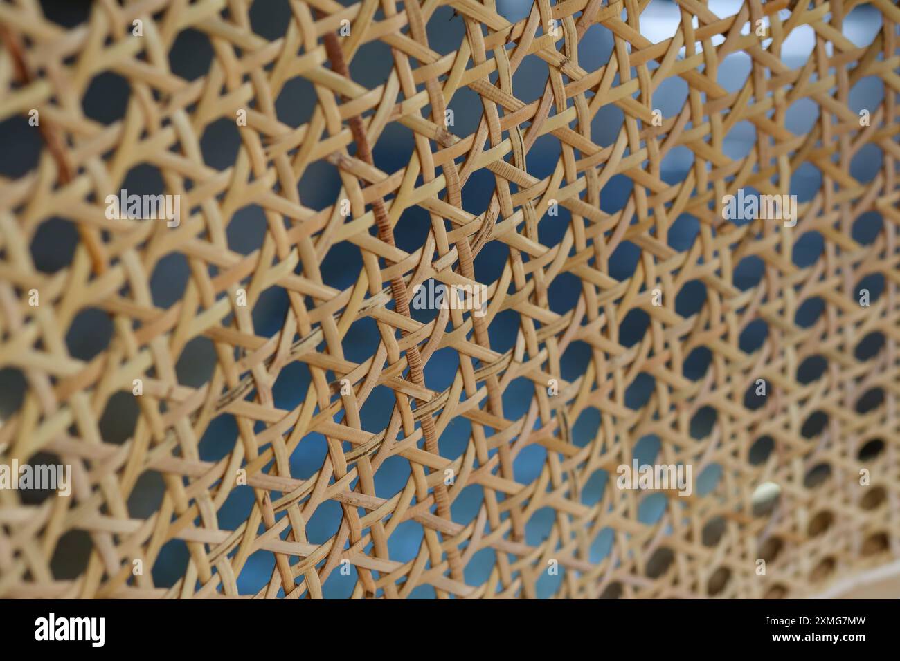 Rattan chain pattern on the back of a vintage chair Stock Photo - Alamy