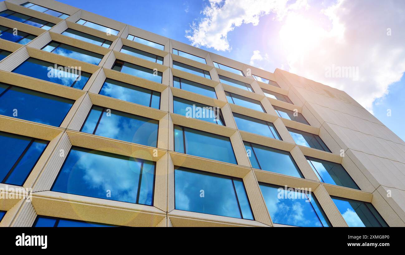 Modern office building with glass facade on a clear sky background ...