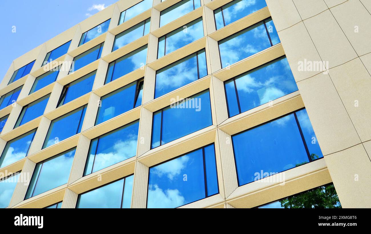 Modern office building with glass facade on a clear sky background ...