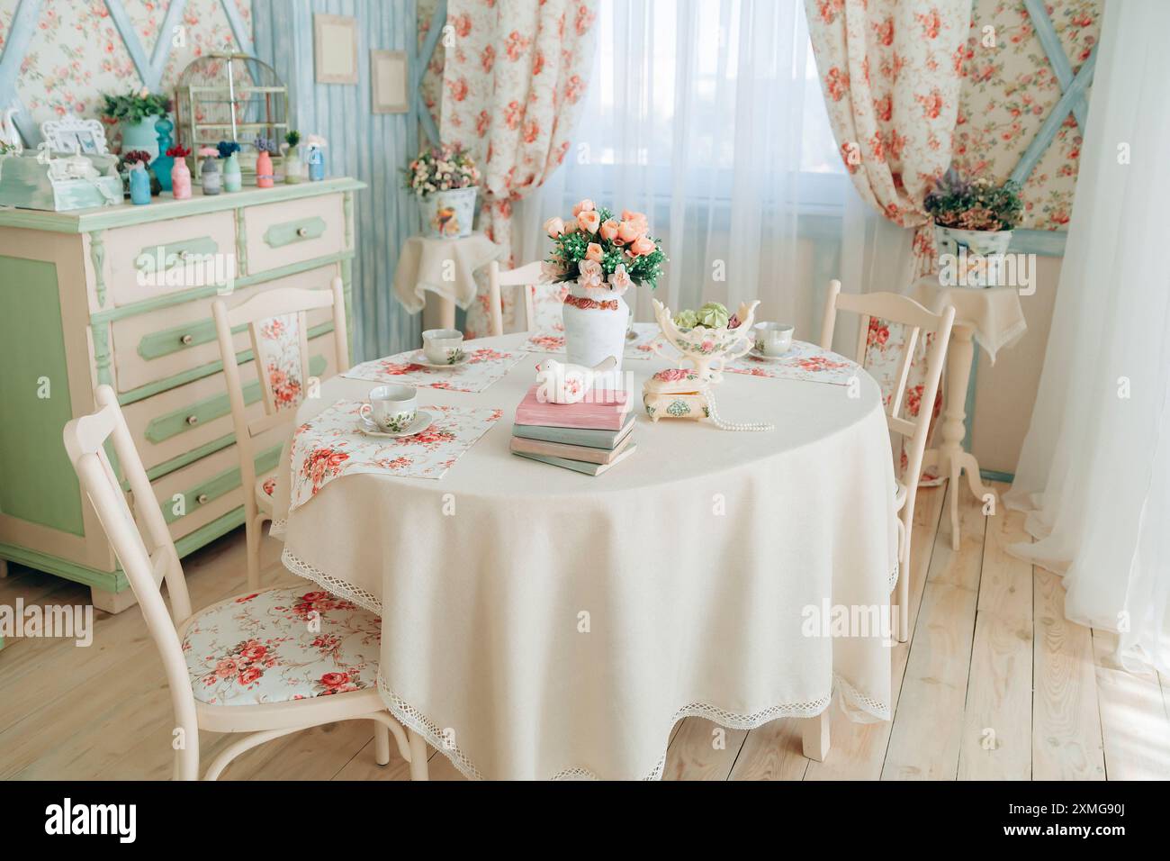 Enchanting vintage dining room with delicate floral patterns, pastel green  furniture, and elegant table set with books and flowers. Sunbeams shine  Stock Photo - Alamy, image size:1300x956
