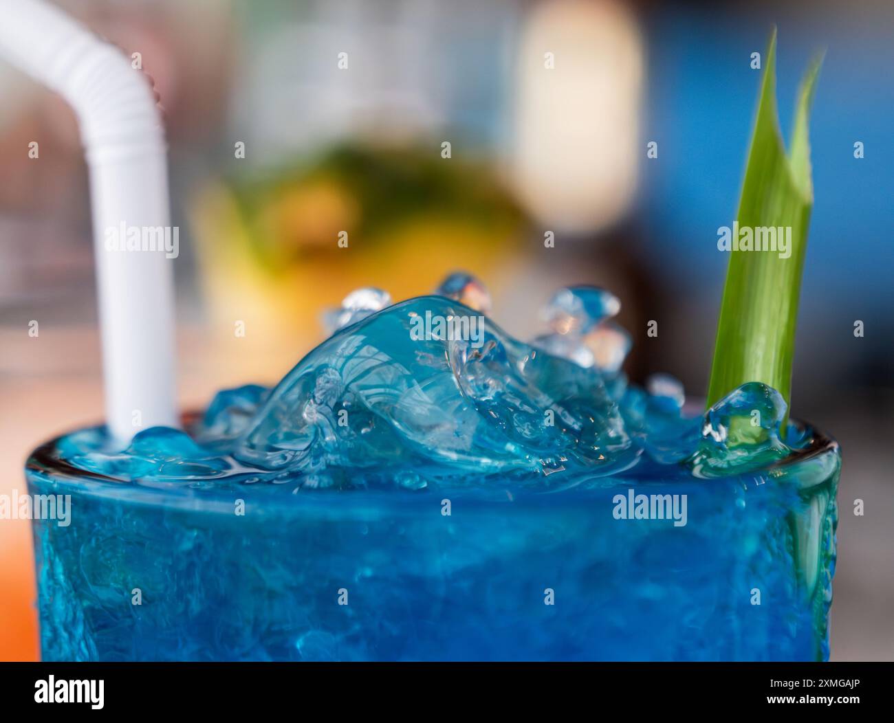 A vibrant blue drink filled with ice in a transparent glass Stock Photo ...