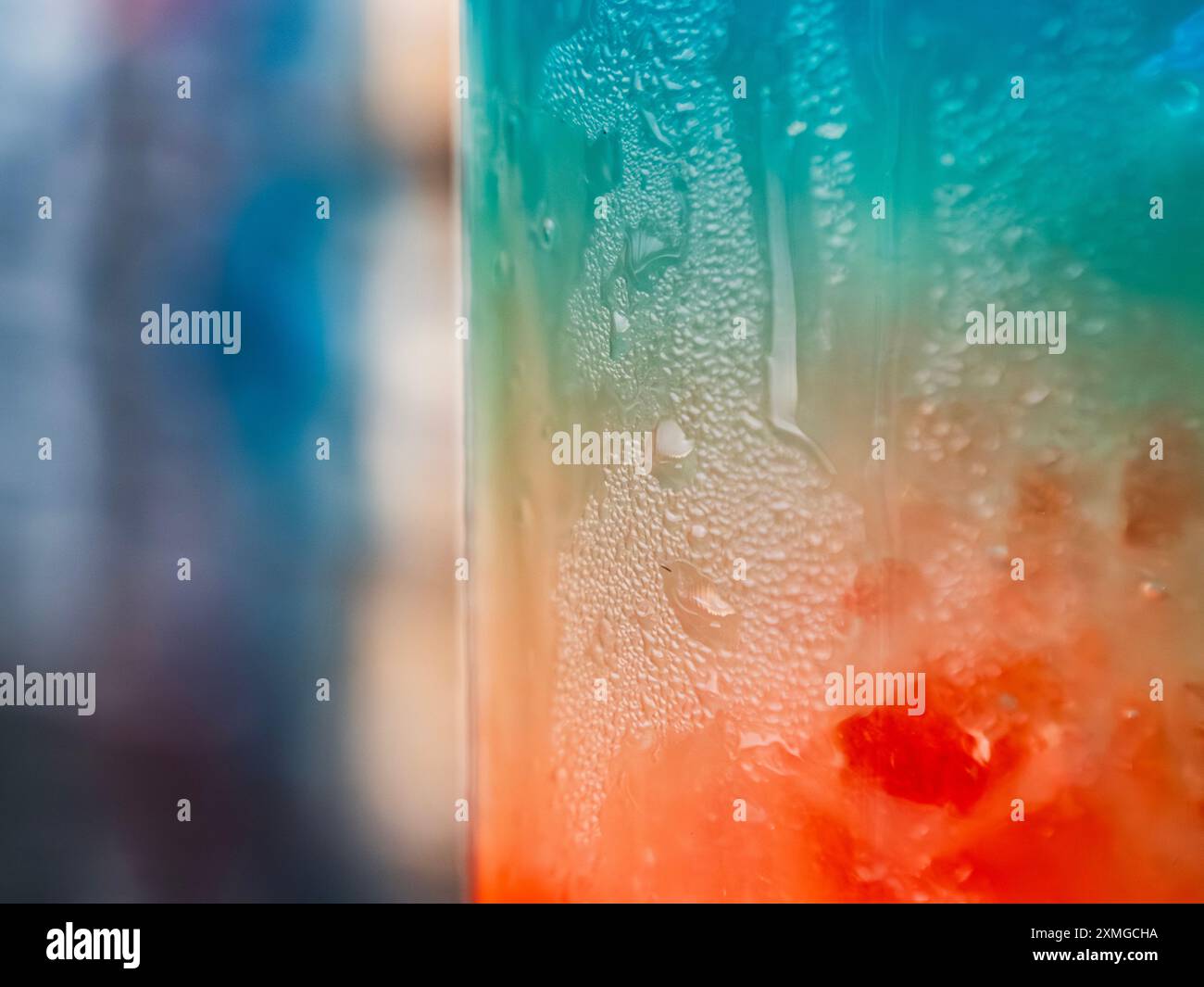 Refreshing colorful beverage in a frosted glass captured on a warm ...