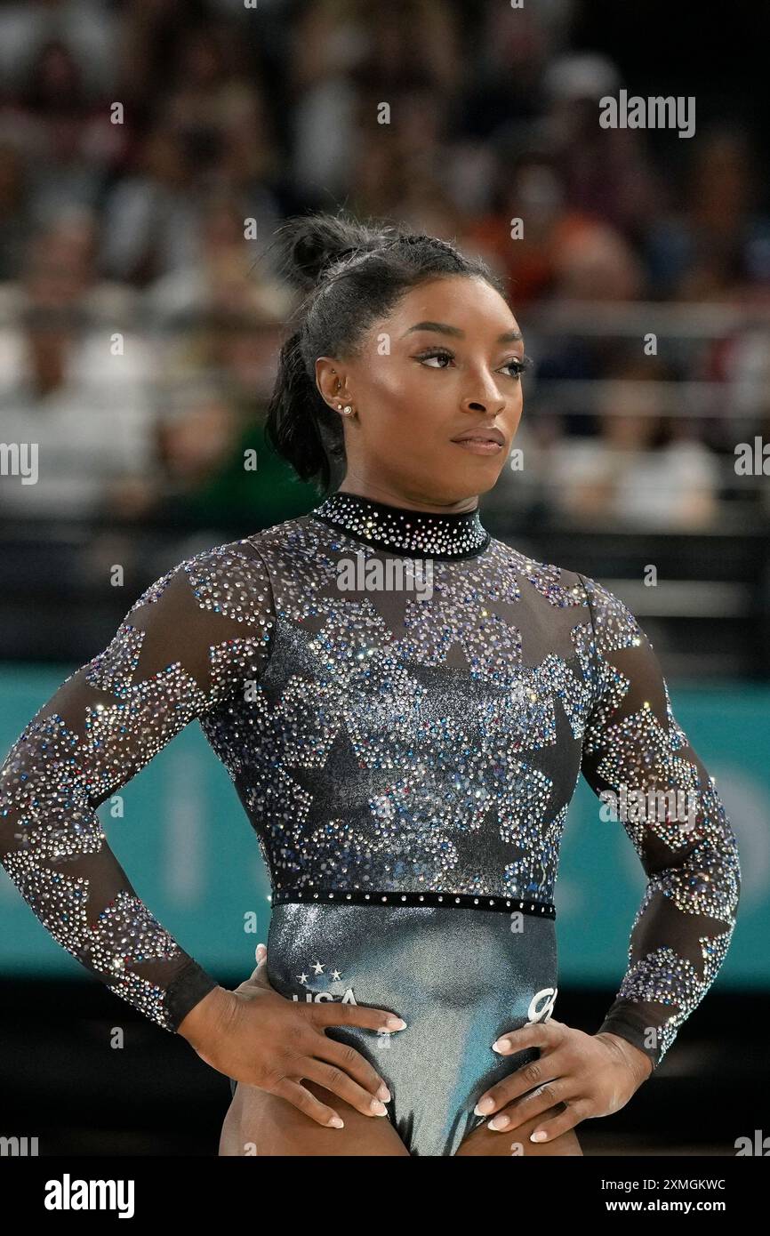 Simone Biles of the United States waits to compete on the balance beam ...