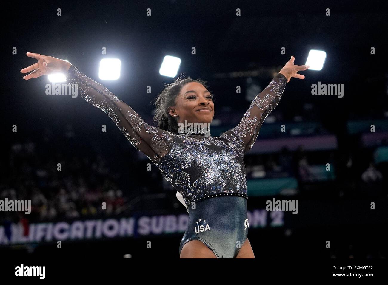 Simone Biles, of United States, smiles after competing on the vault ...