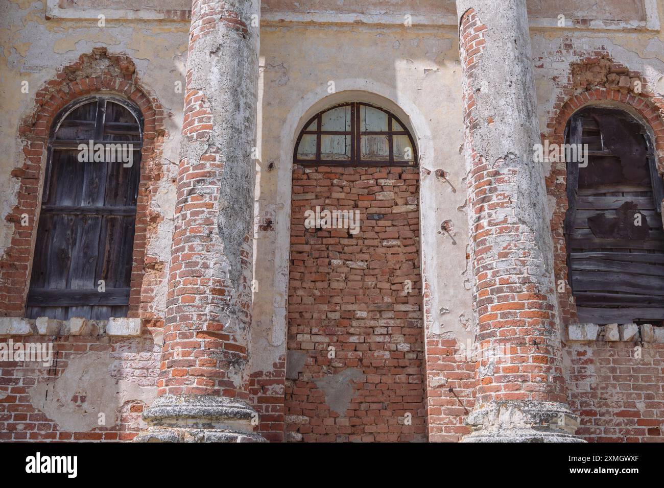 Facade of an abandoned church featuring weathered columns and ...
