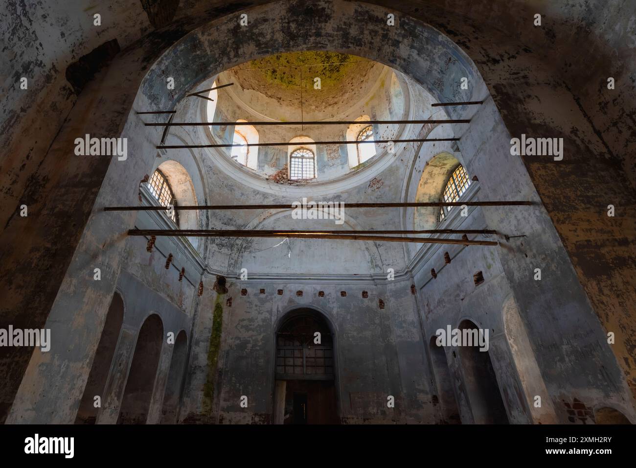 The interior of an abandoned church featuring decaying walls, broken ...
