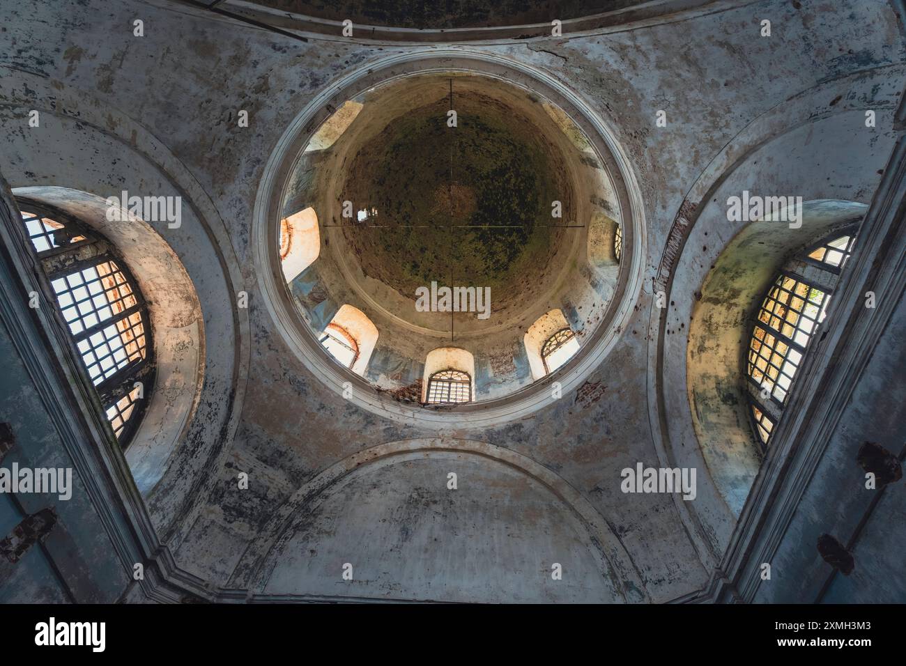 The interior of an abandoned church featuring decaying walls, broken ...