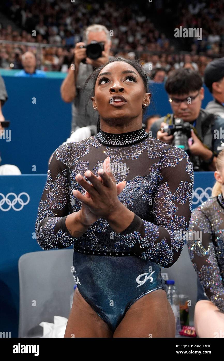 Simone Biles of United States, celebrates after competing on the uneven ...