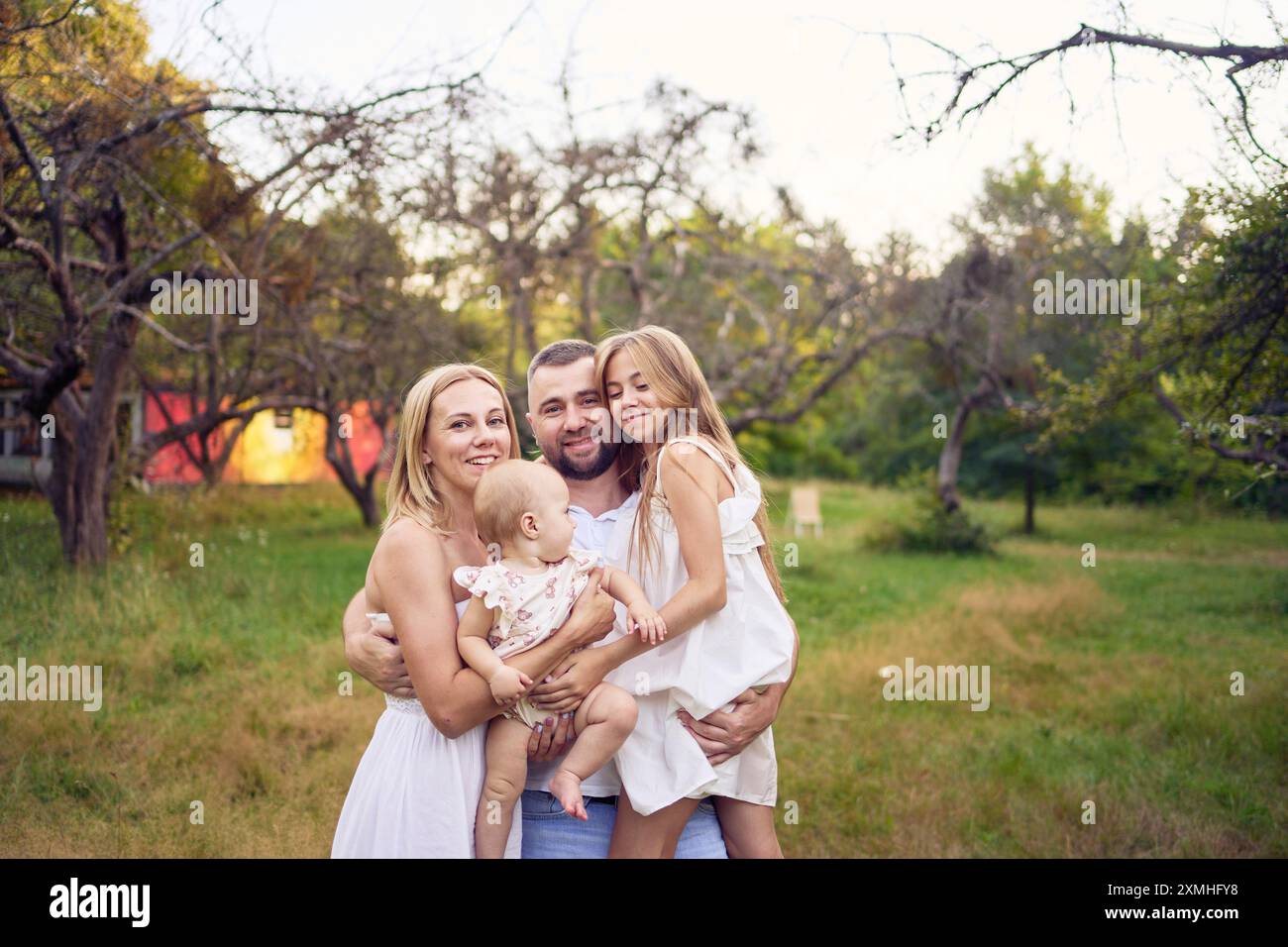 a family of four on a walk in the park Stock Photo - Alamy