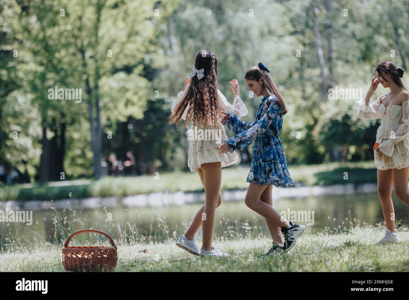 Carefree young women enjoying a sunny day in the park, laughing and ...