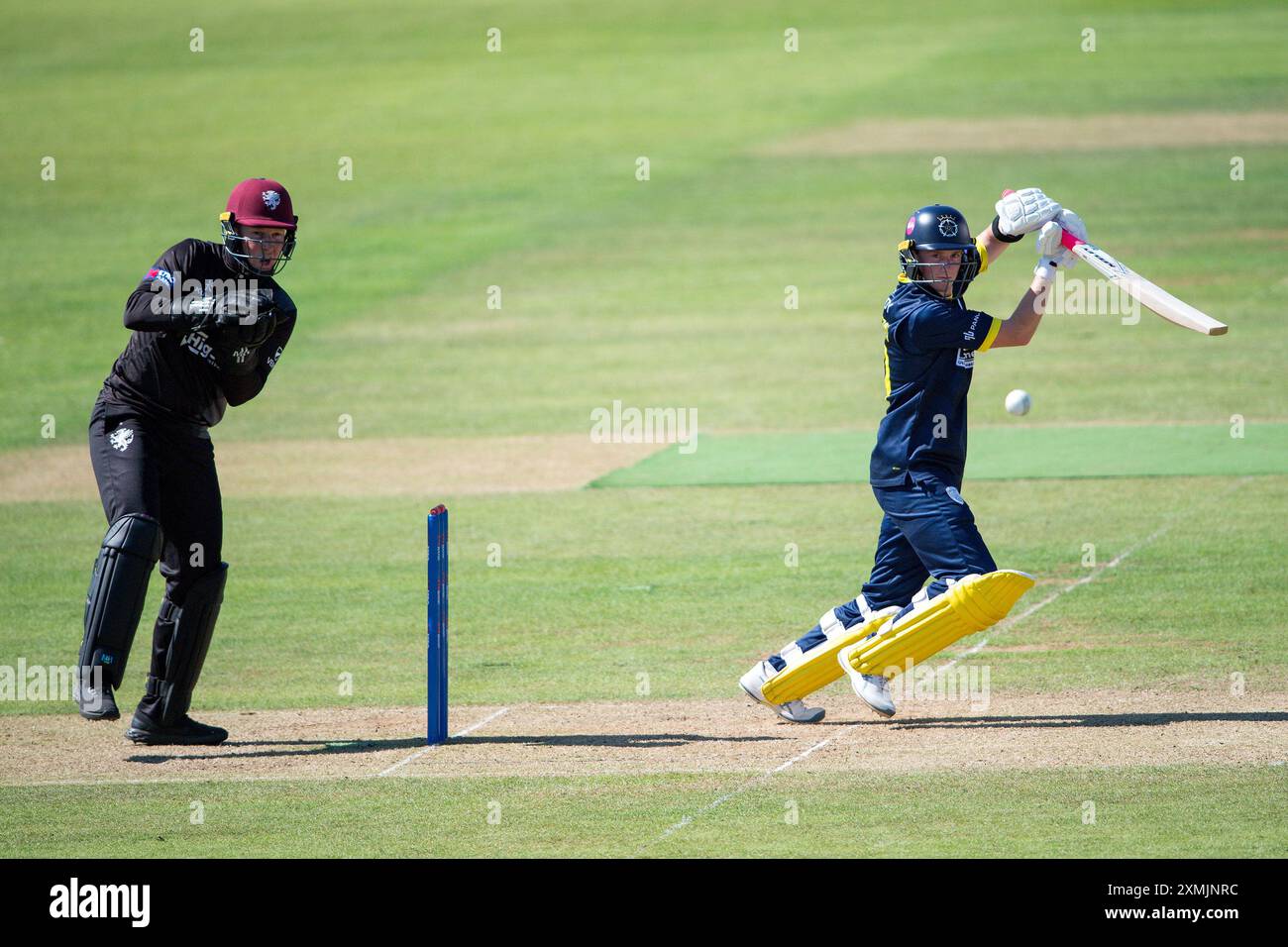 Southampton, UK. 28 July 2024. Fletcha Middleton of Hampshire batting as James Rew looks on from behind the sumps during the Metro Bank One Day Cup match between Hampshire and Somerset at Utilita Bowl. Credit:Dave Vokes/Alamy Live News Stock Photo