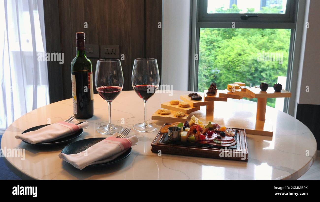 Elegant dining setup with red wine, artisan cheese, and charcuterie ...