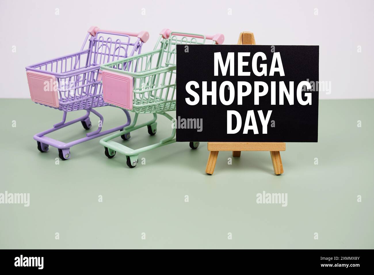 Mega Shopping Day text message and trolley shopping cart on green ...