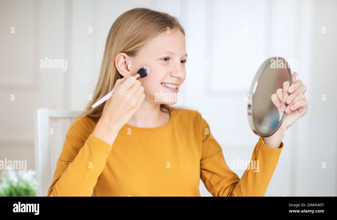 Teen girl applying lipstick hi-res stock photography and images - Alamy